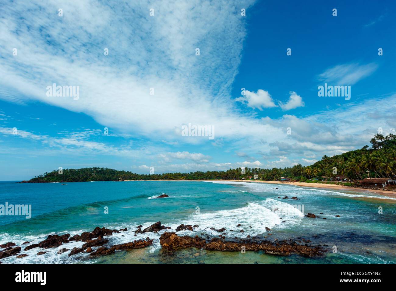 Mirissa beach in Sri Lanka in daytime with clouds and waves in sea ...