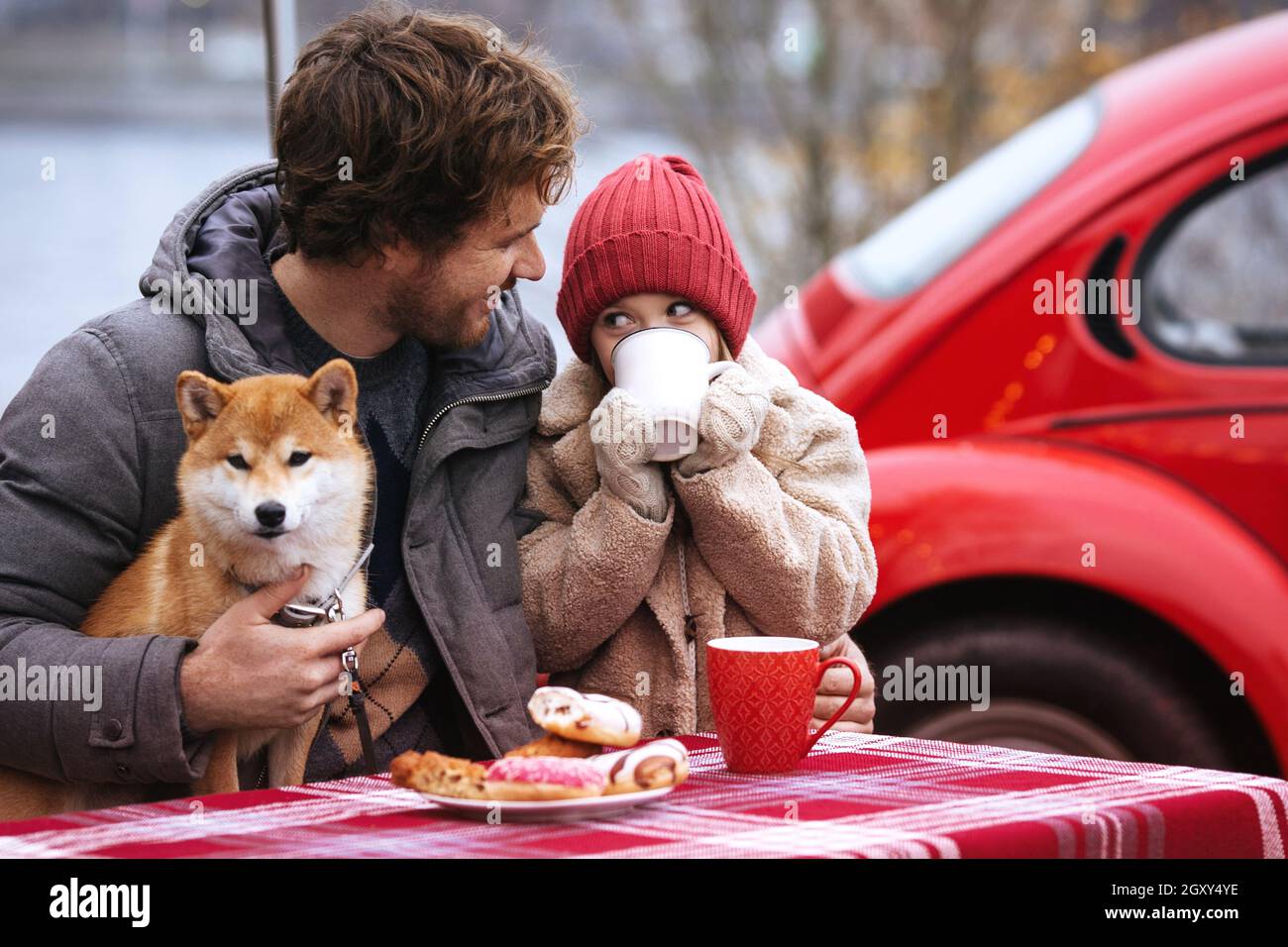 Young father travel with small daughter by car have sneak outside on winter holidays. Family love Stock Photo