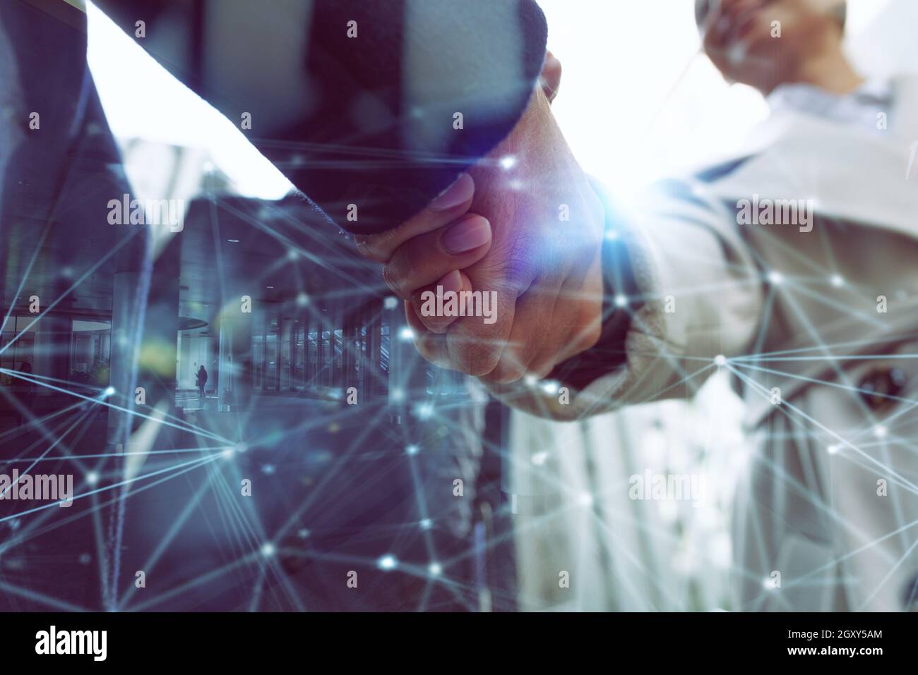 Handshaking business person in office as teamwork Stock Photo - Alamy