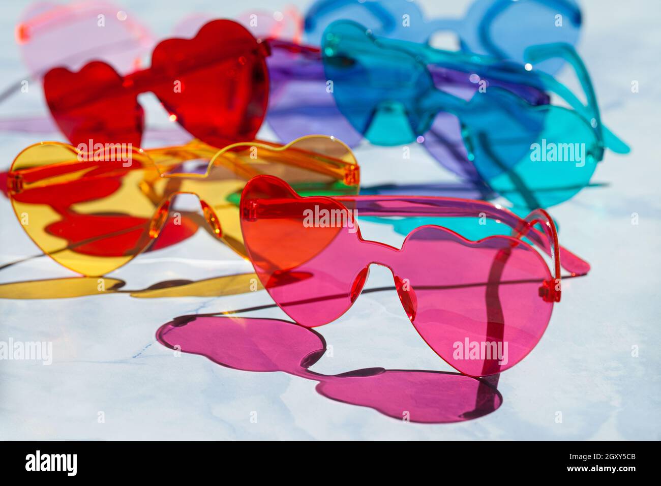 Colorful sunglasses in heart shaped on a blue background Stock Photo
