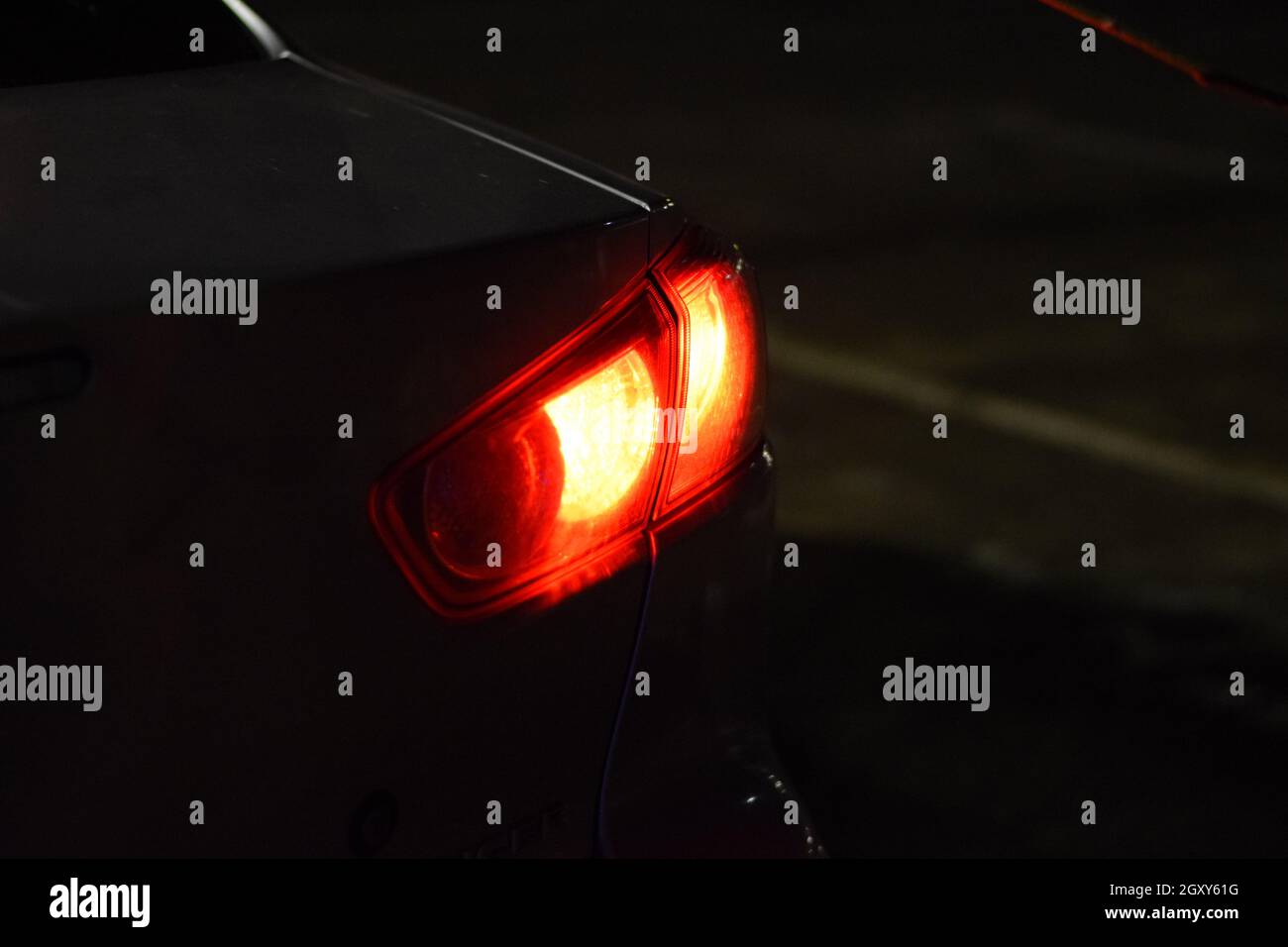 Discounted rear car lights in the dark. Stop signals Stock Photo Alamy