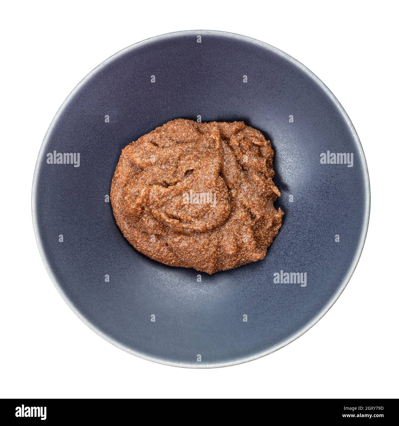 top view of boiled porridge from teff grains in gray bowl isolated on white background Stock Photo