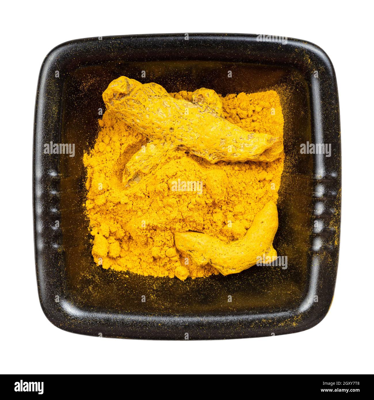 Turmeeic top view of Turmeric (Curcuma) powder and roots in black bowl isolated ...