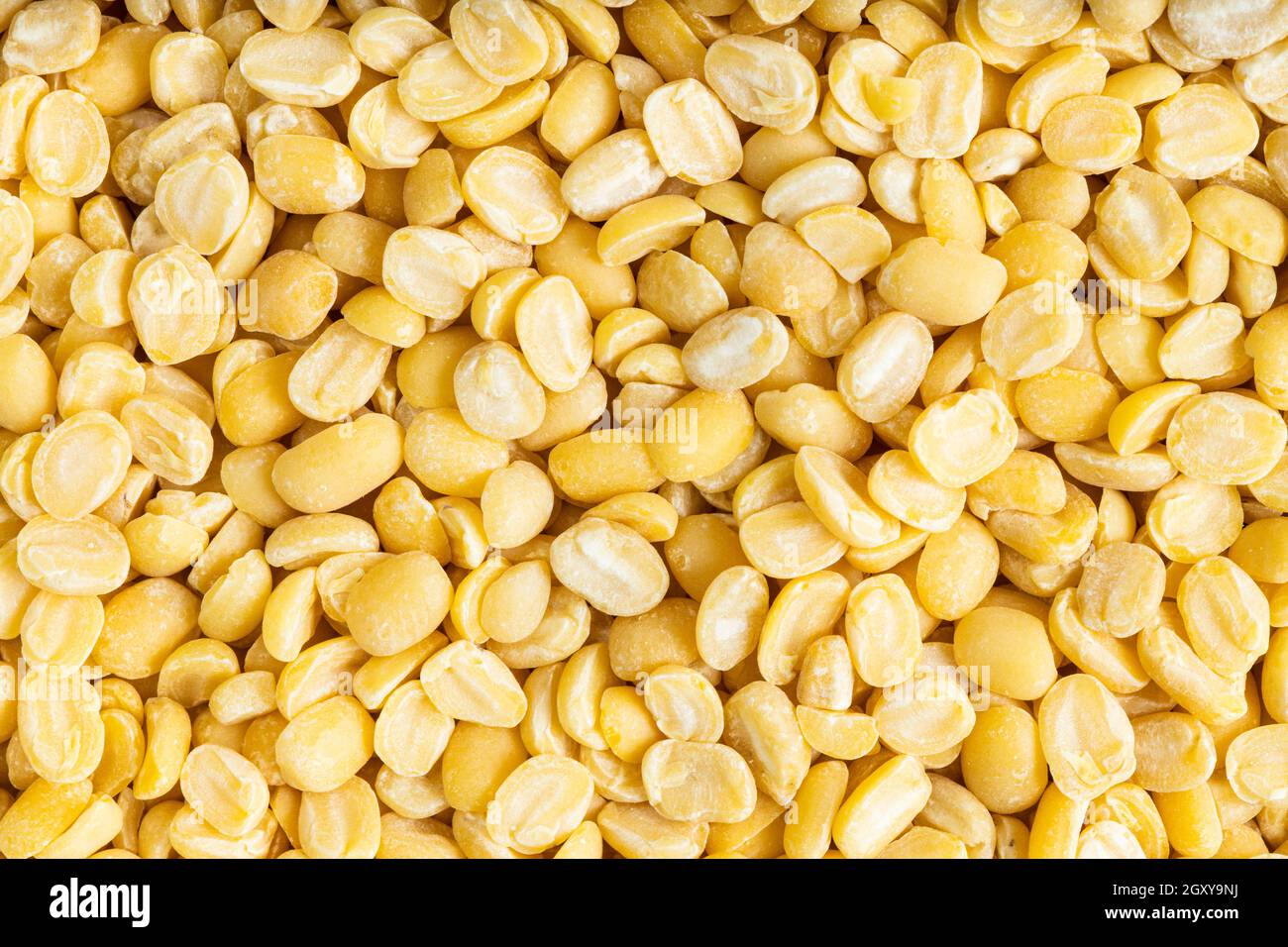 food background - many raw moong dal (split green mung) beans close up Stock Photo