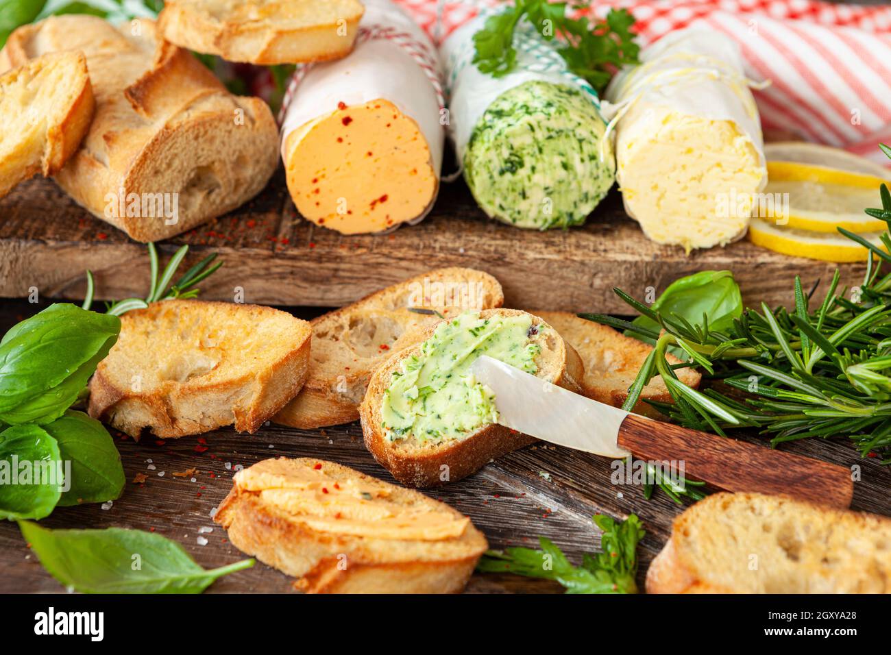 Homemade herb butter with slices of roasted baguette Stock Photo
