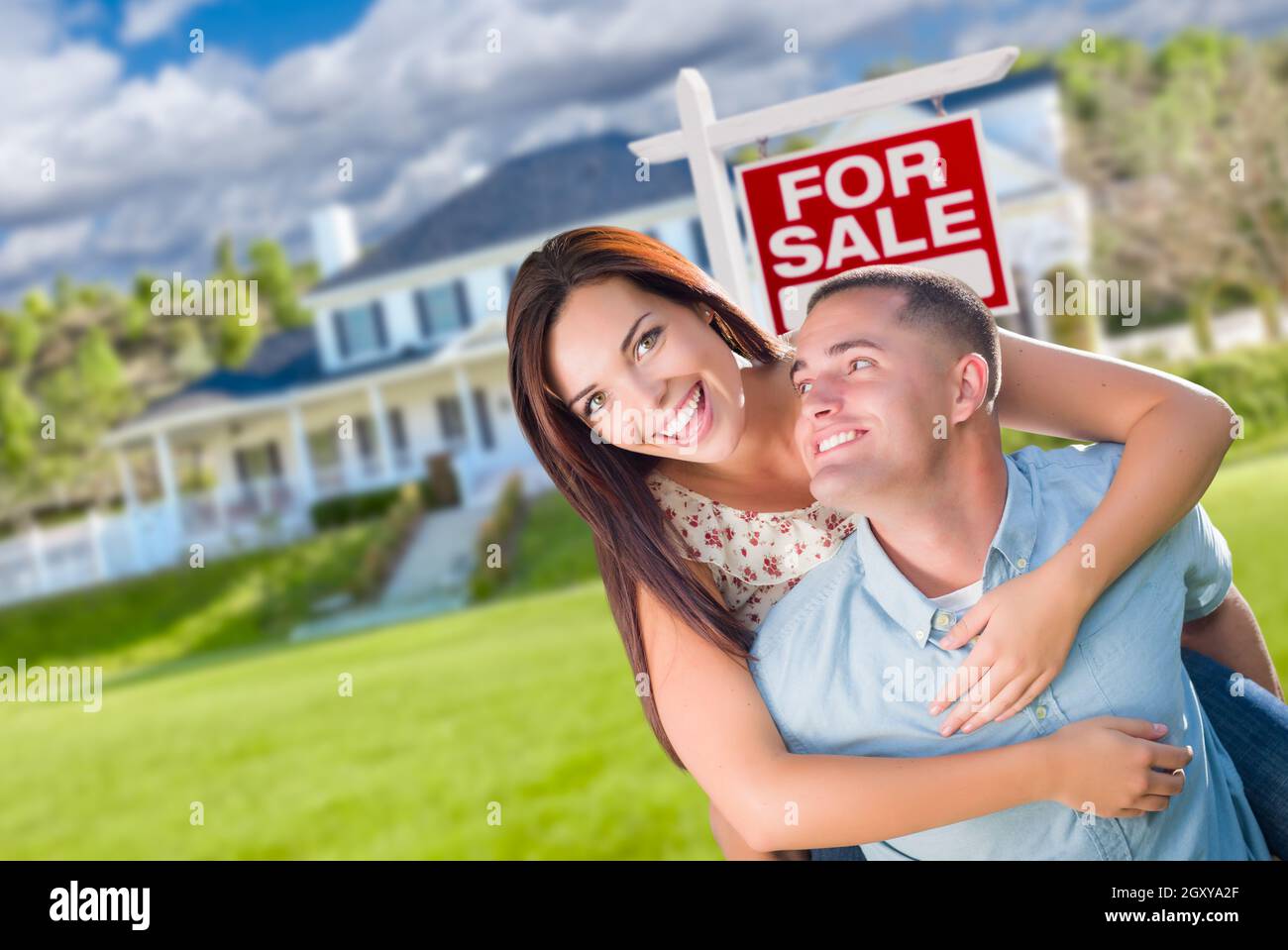 Playful Excited Military Couple In Front of Home with For Sale Real ...
