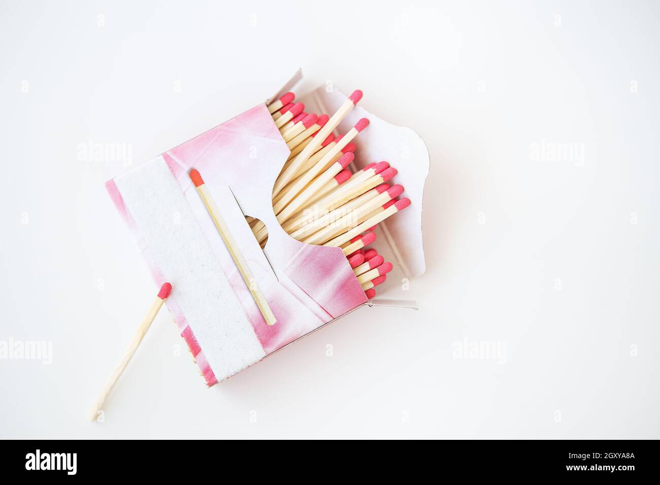 Long matches with a red head on a white background. Kitchen, ignition