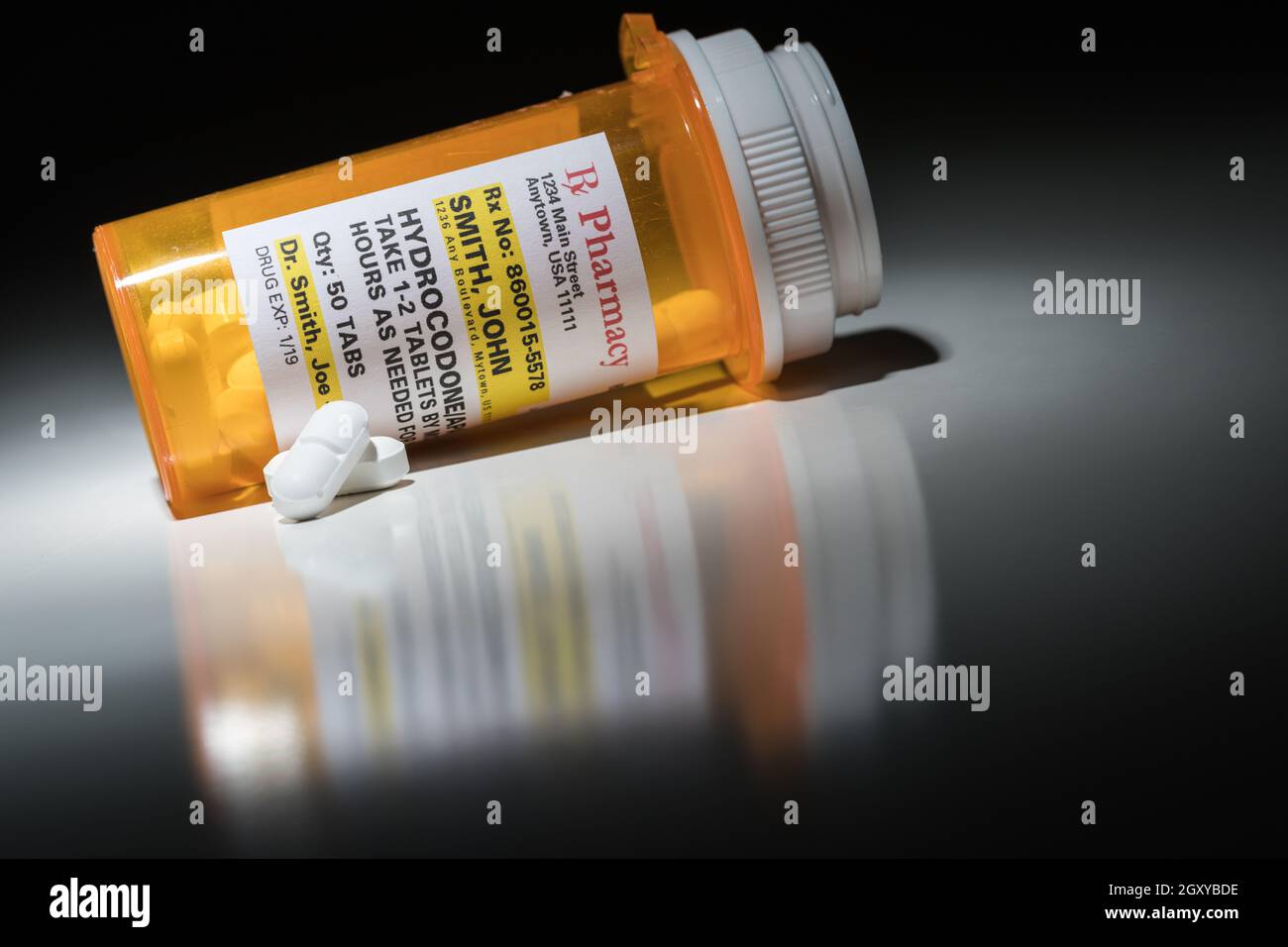 Hydrocodone Pills and Prescription Bottle with Non Proprietary Label. No model release required - contains fictitious information. Stock Photo