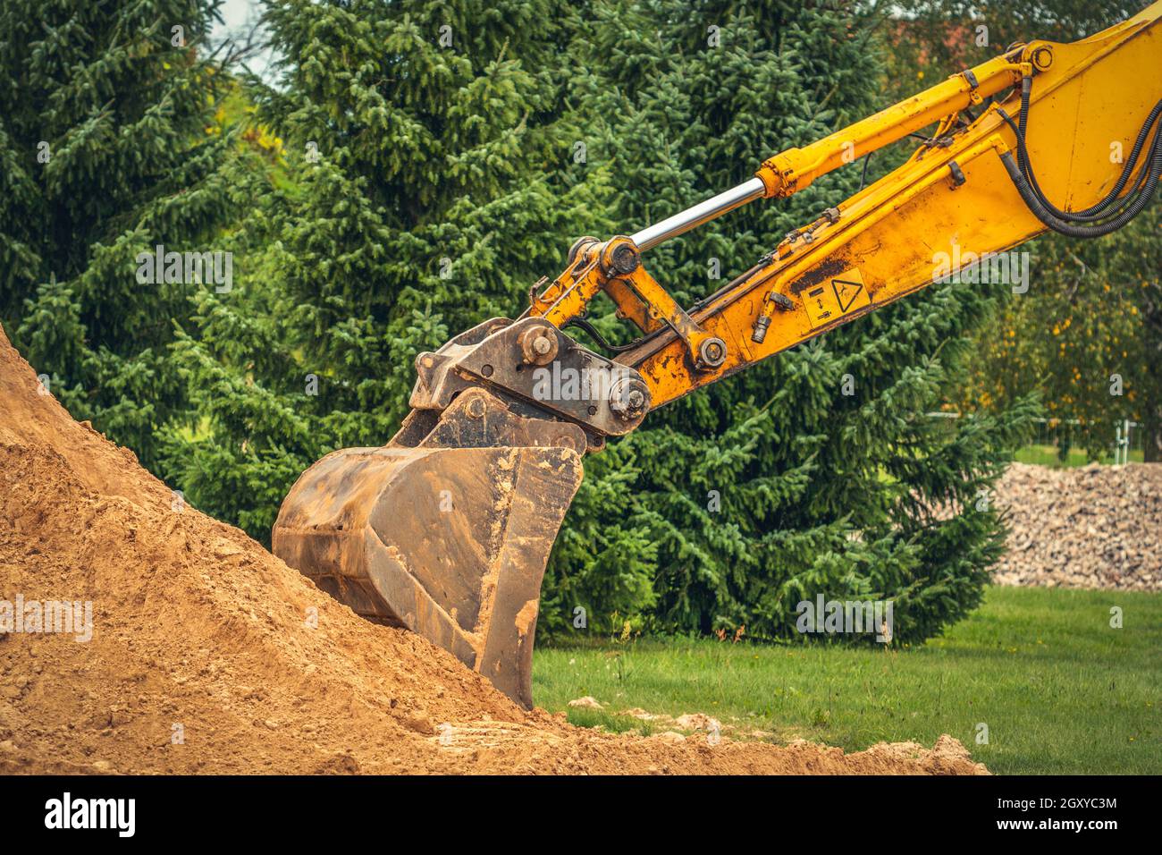 Working excavator bucket. Excavation work. Power shovel moving soil and stones. Digging building