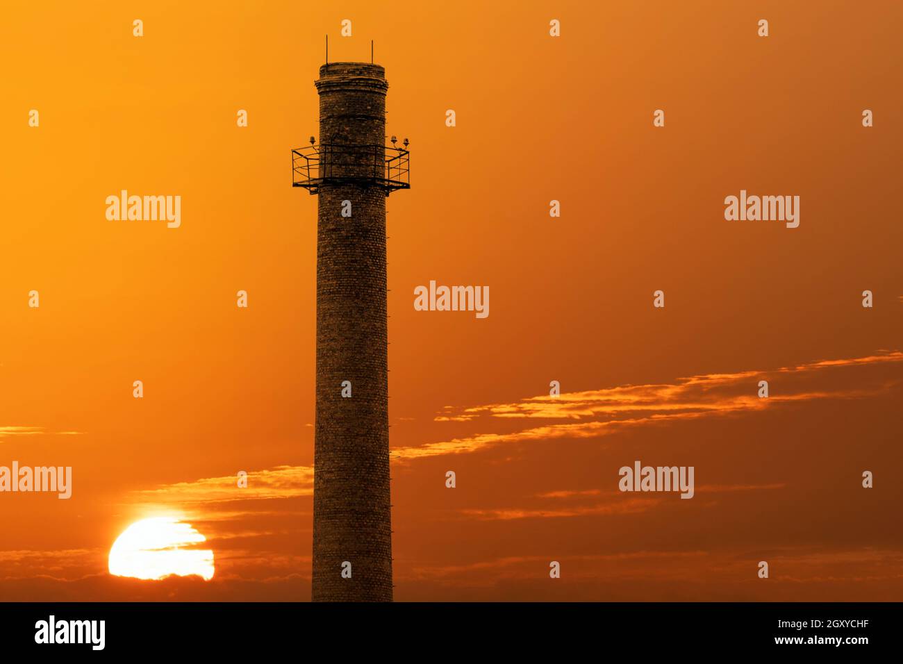 An old factory brick chimney against a sunset sky background Stock ...