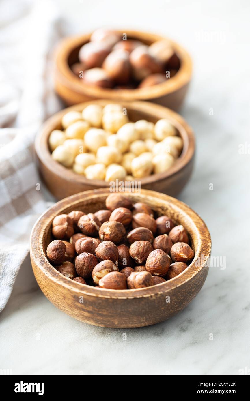 Peeled roasted hazelnut kernels in bowl. Stock Photo