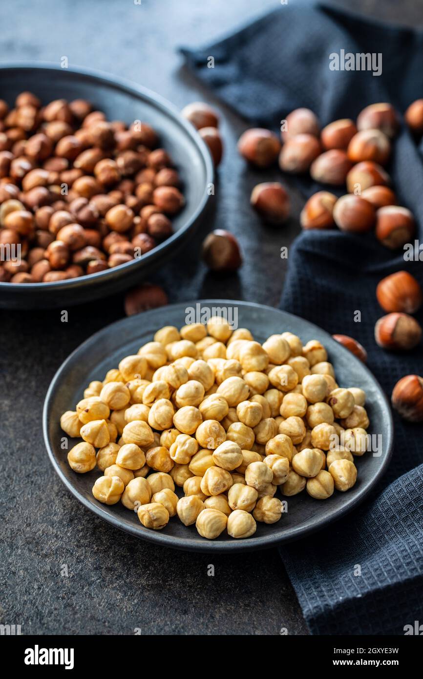 Peeled roasted hazelnut kernels in bowl. Stock Photo