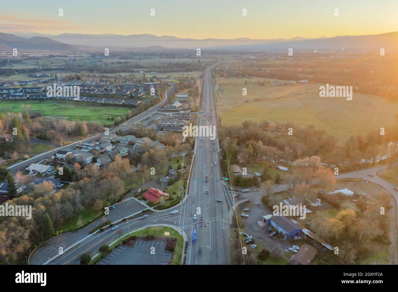 Peaceful town surrounded by trees with mountains as background during