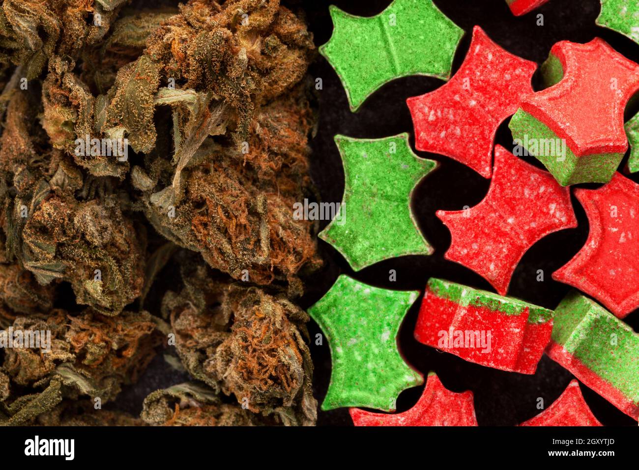 Marijuana and Ecstasy close up. Colorful pills and cannabis buds. Stock Photo