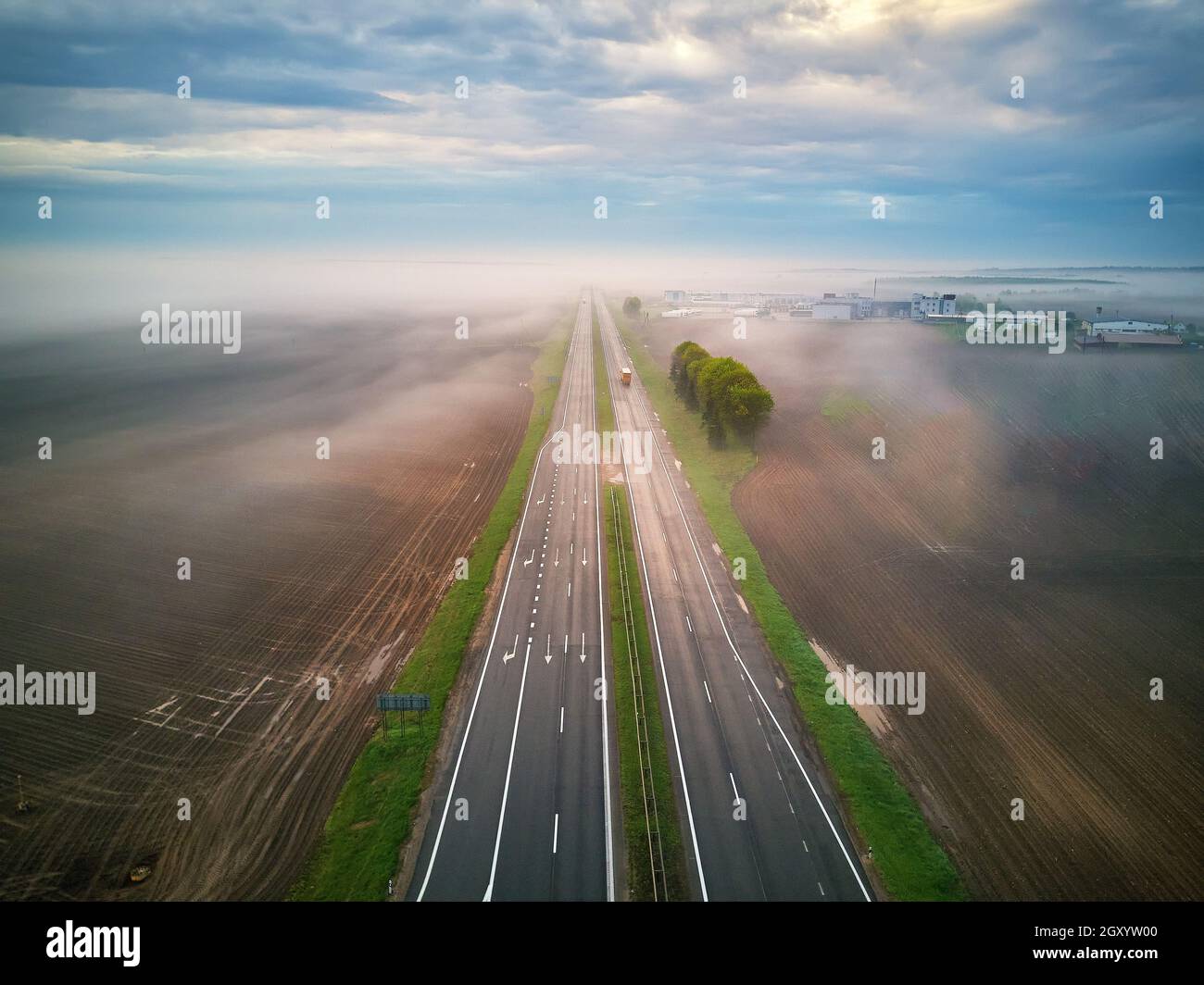 Aerial view of a highway covered by fog. Early misty morning. Road in ...