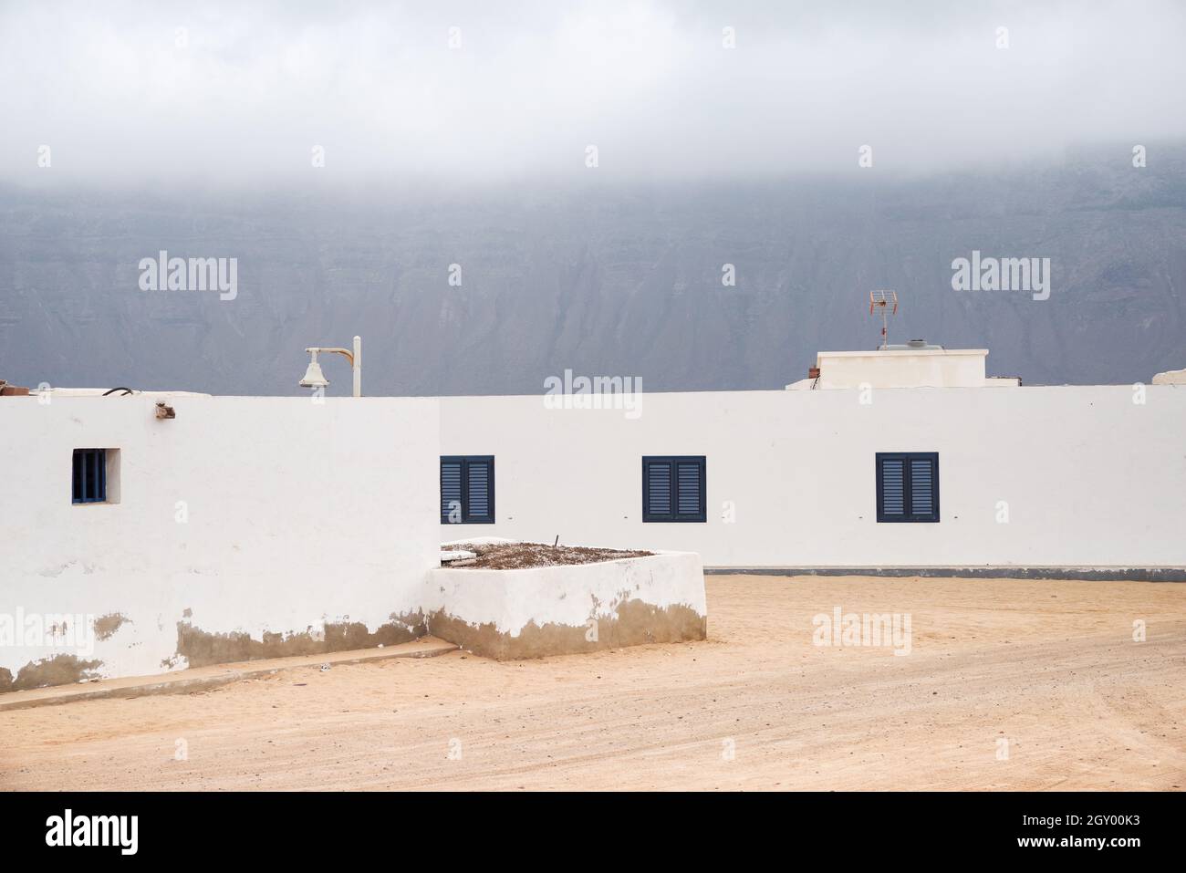 Moody skies over La Graciosa island, with the cliffs of Lanzarote mainland visible in the background Stock Photo