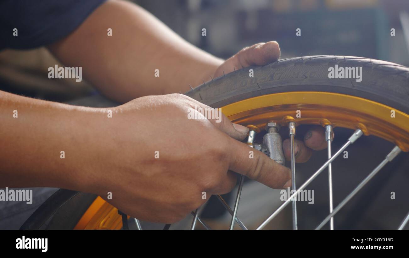 Motorcycle check tire inflation, motorcycle service or maintenance and condition inspection pump