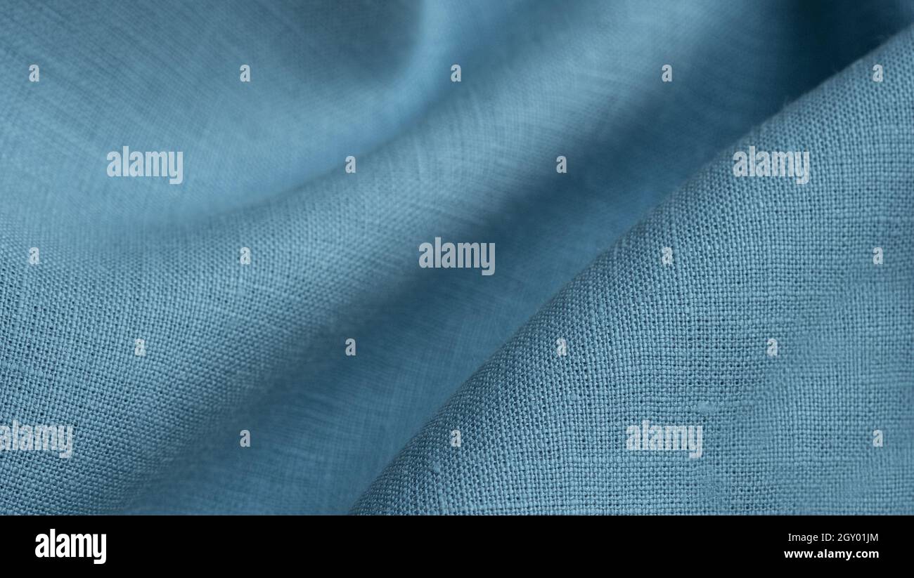Linen fabric, blue background. Soft linen blue fabric texture. Textured fabric background. Macro with shallow dof Stock Photo