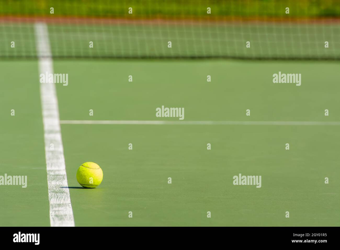 Green tennis balls are in a tennis court Stock Photo Alamy