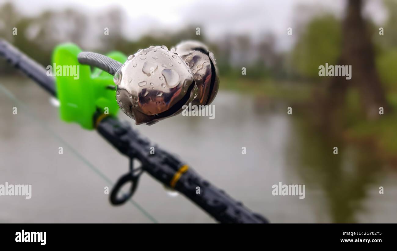 Silver fishing bells are worn on a fishing rod while fishing. Bitecall signal, at the tip of