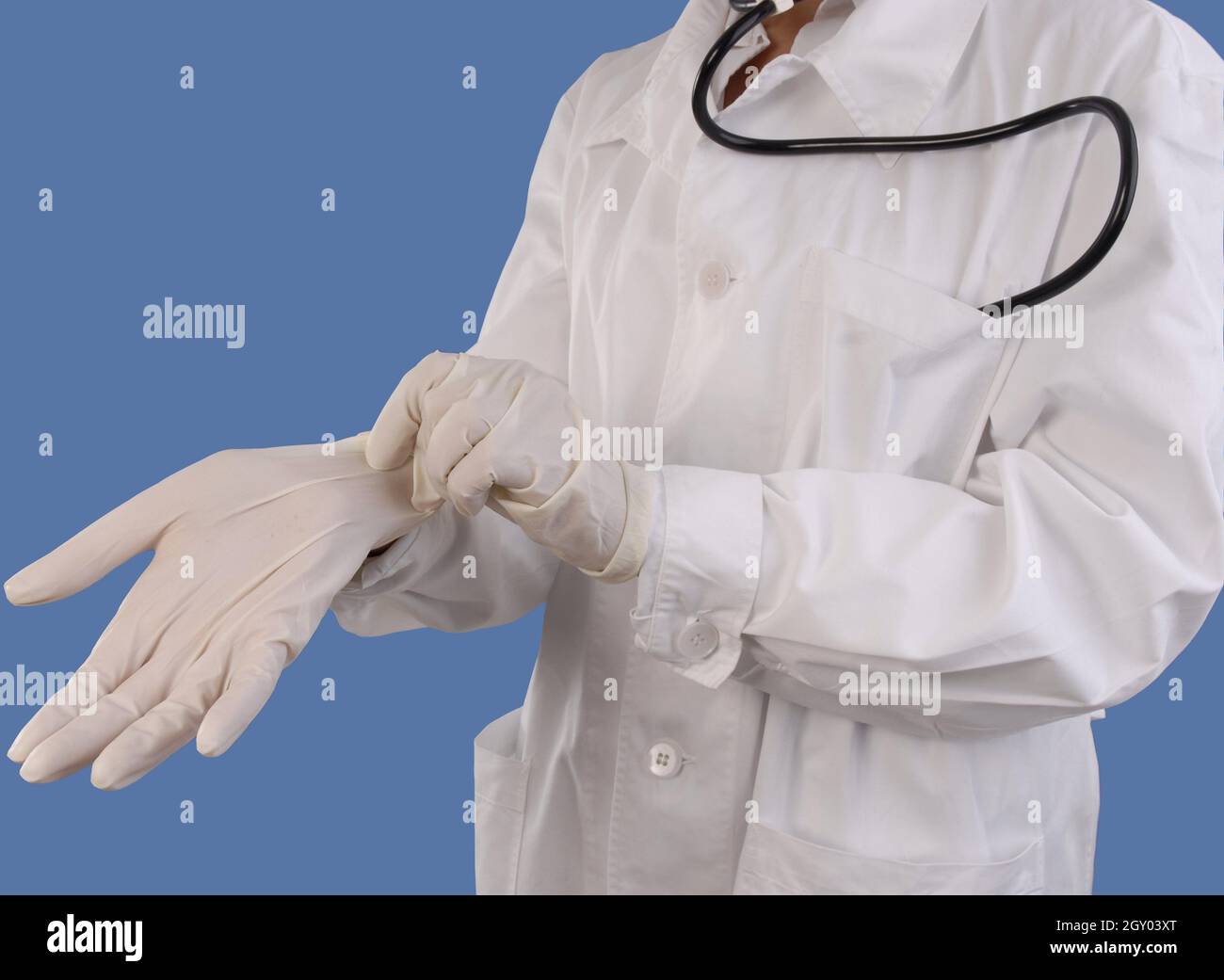 female doctor putting on latex gloves Stock Photo