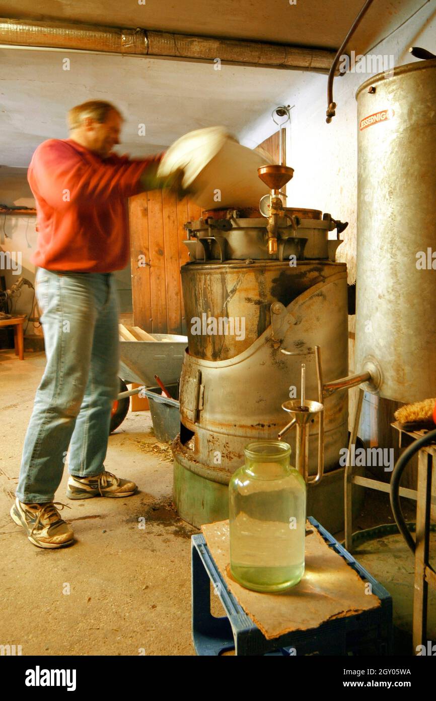 man at kiln in a schnaps destillery, Austria Stock Photo