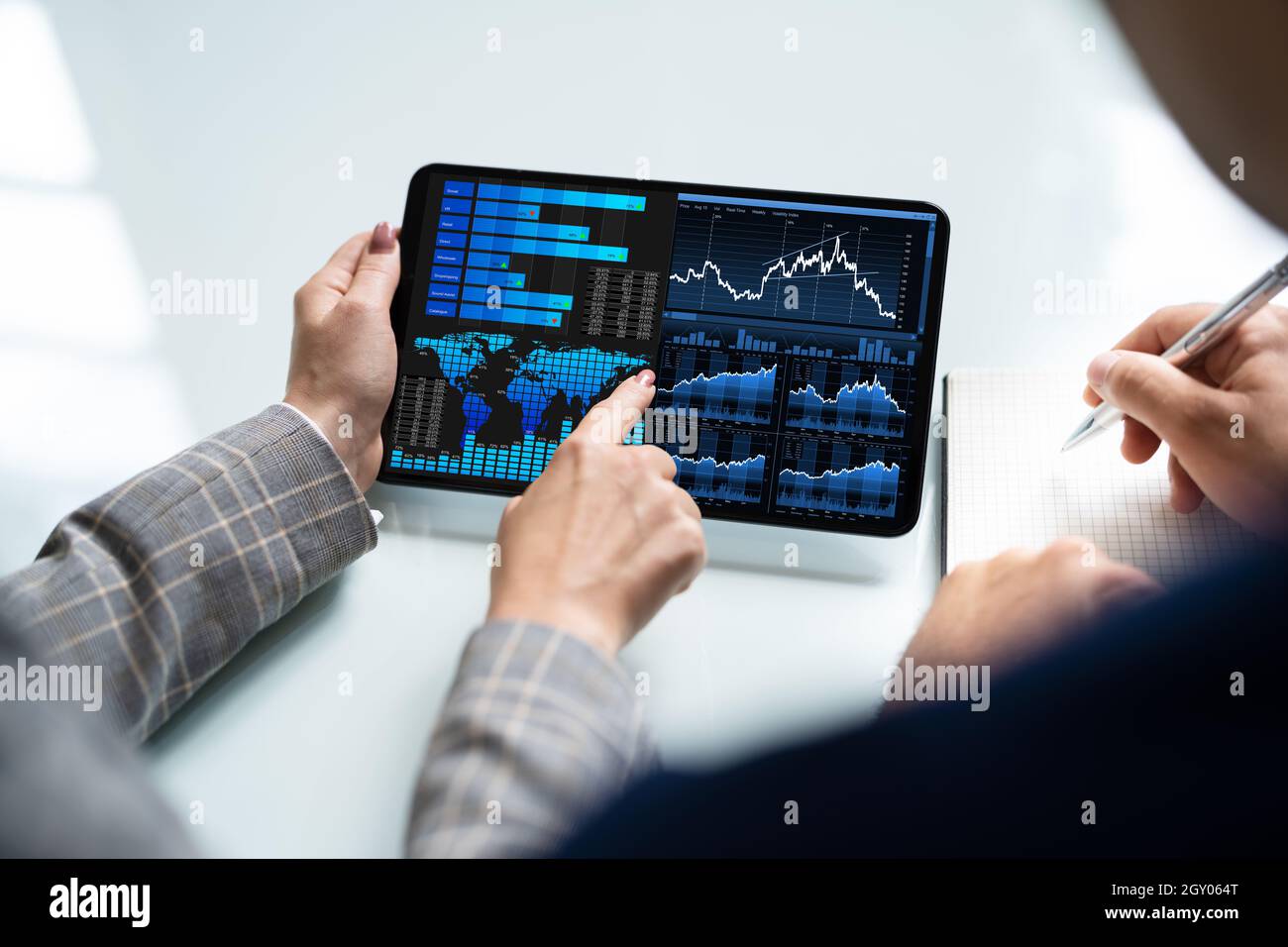 Two Analyst Using KPI Dashboard On Tablet Computer Stock Photo