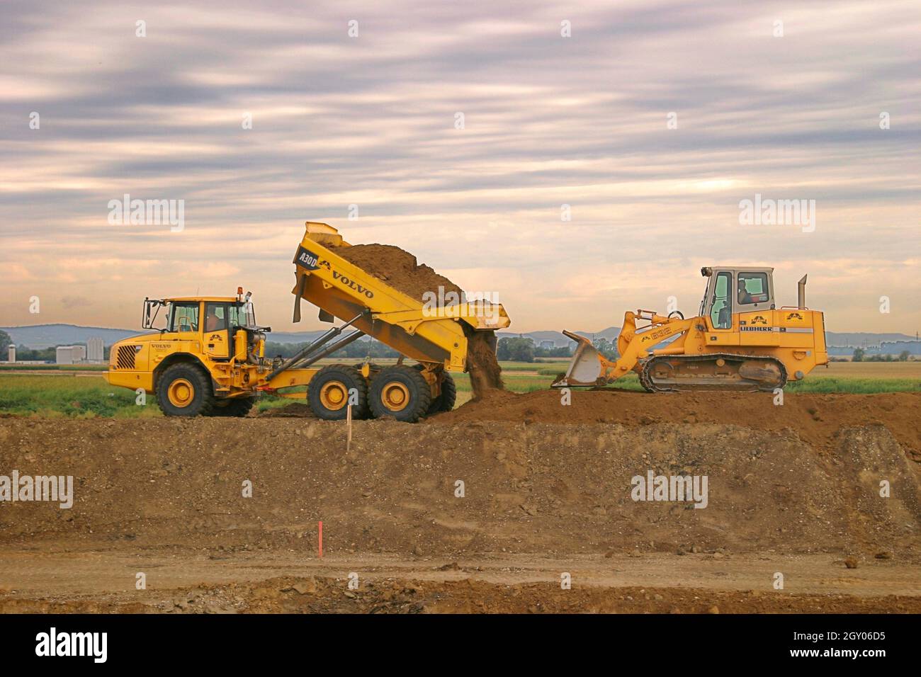 Crawler-type vehicle and truck on a building site, Austria Stock Photo