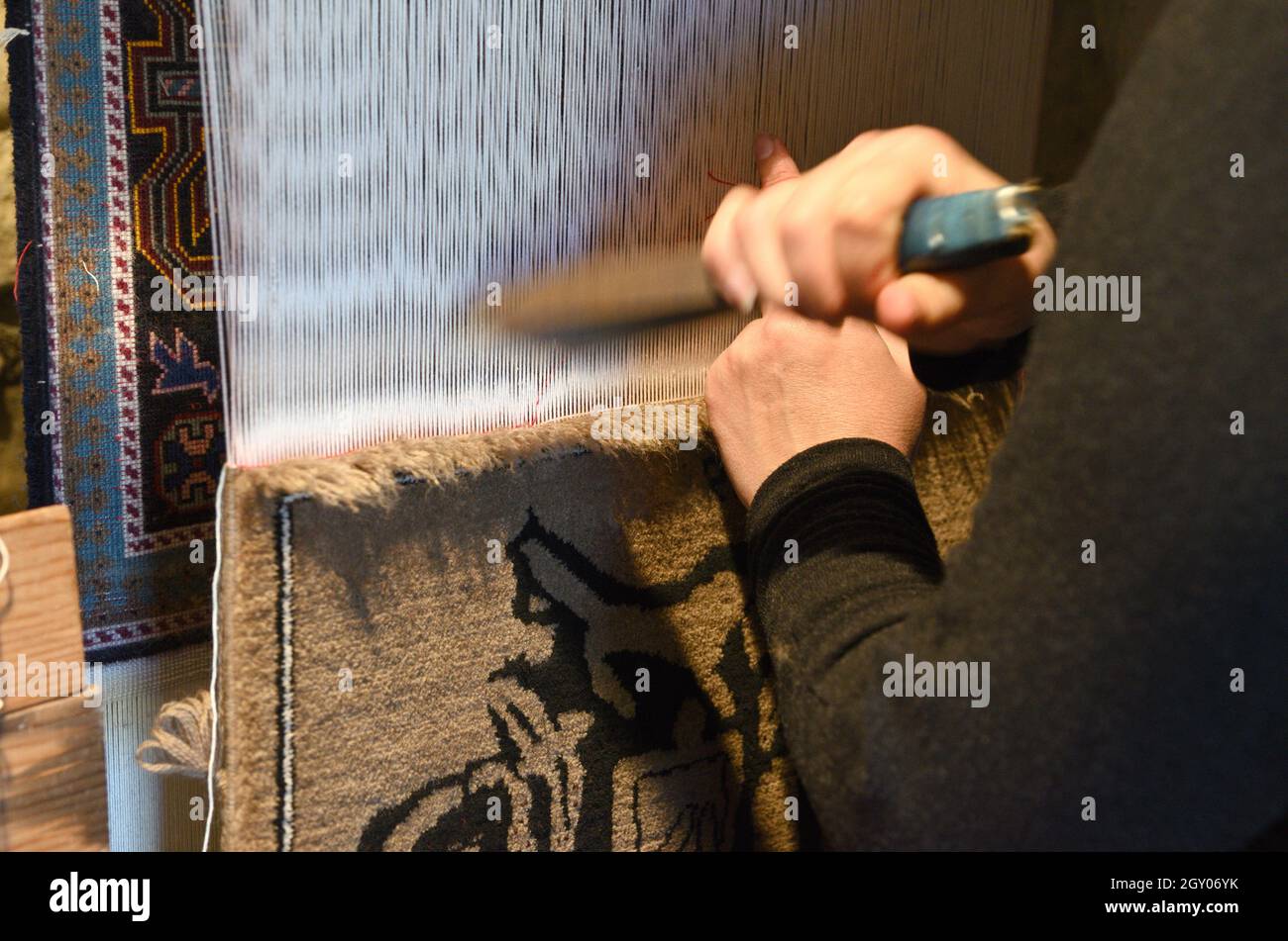 Masters of carpet weaving for knitting carpets Stock Photo Alamy