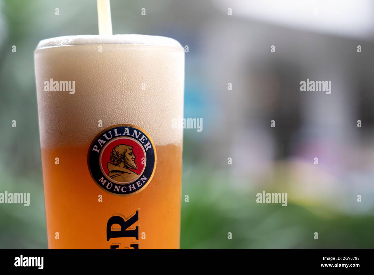 glass of cold Paulaner beer of belgium on bar counter, ready to serve