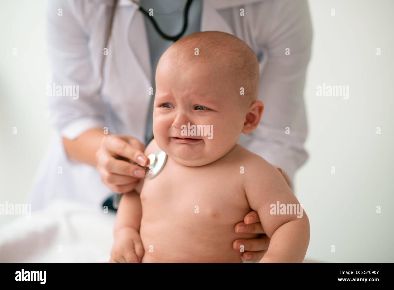 Crying little patient undergoing the chest auscultation Stock Photo Alamy