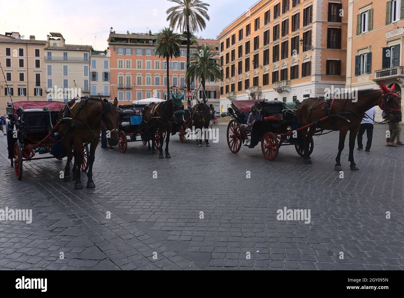 ROME, ITALY - Sep 01, 2019: Four horses and beautiful old carriages on a stone-paved street in Rome, Italy Stock Photo