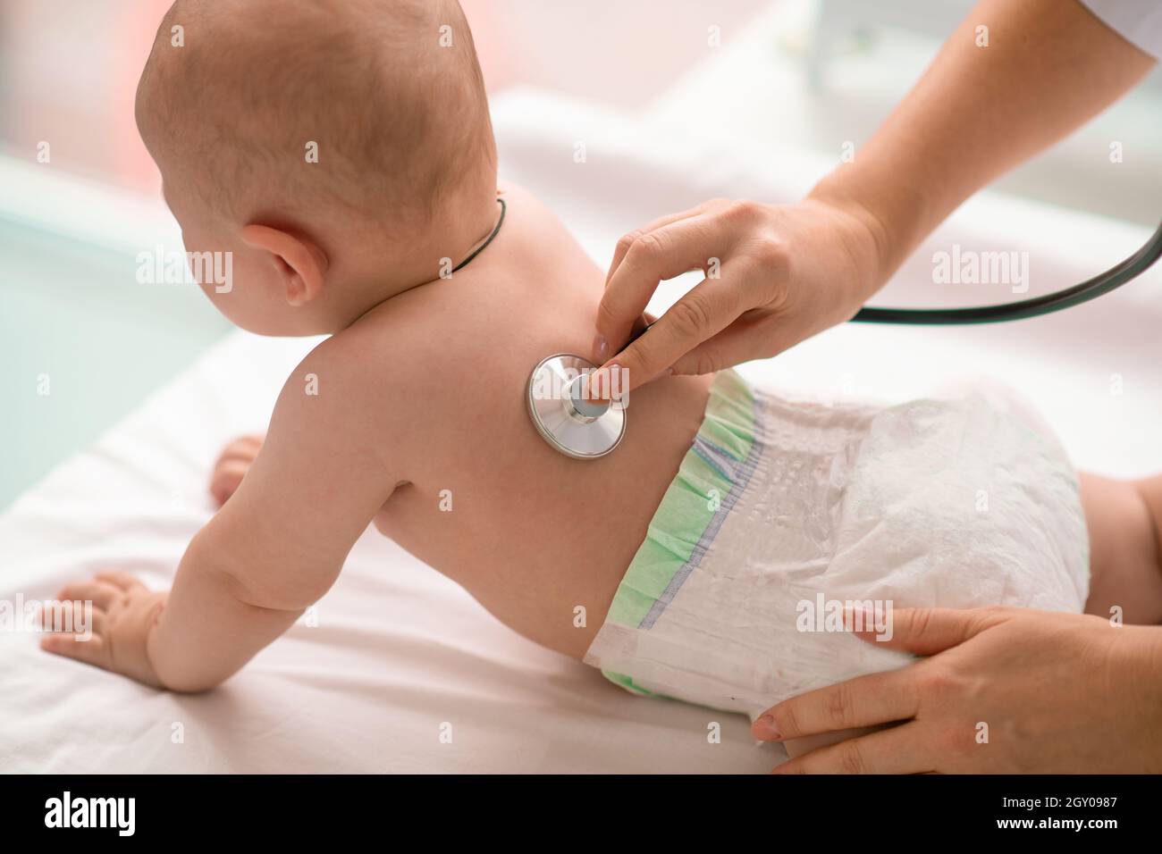 Baby undergoing the auscultation performed by an experienced doctor Stock Photo