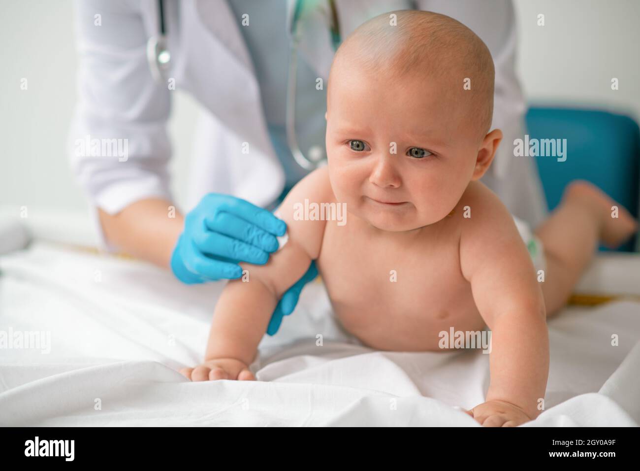 Tranquil baby being prepared for an injection Stock Photo