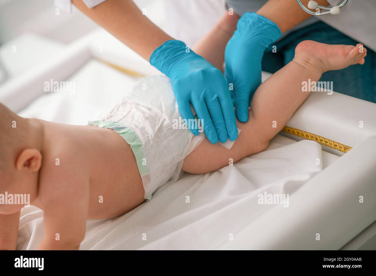 Baby undergoing skin disinfection before a medical procedure Stock Photo