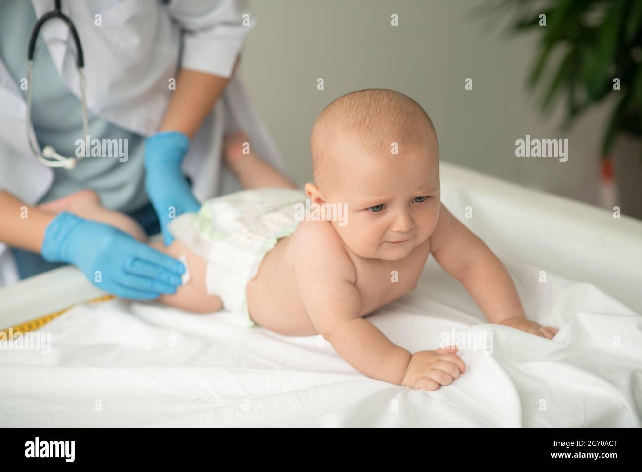 Baby being prepared for a thigh injection Stock Photo