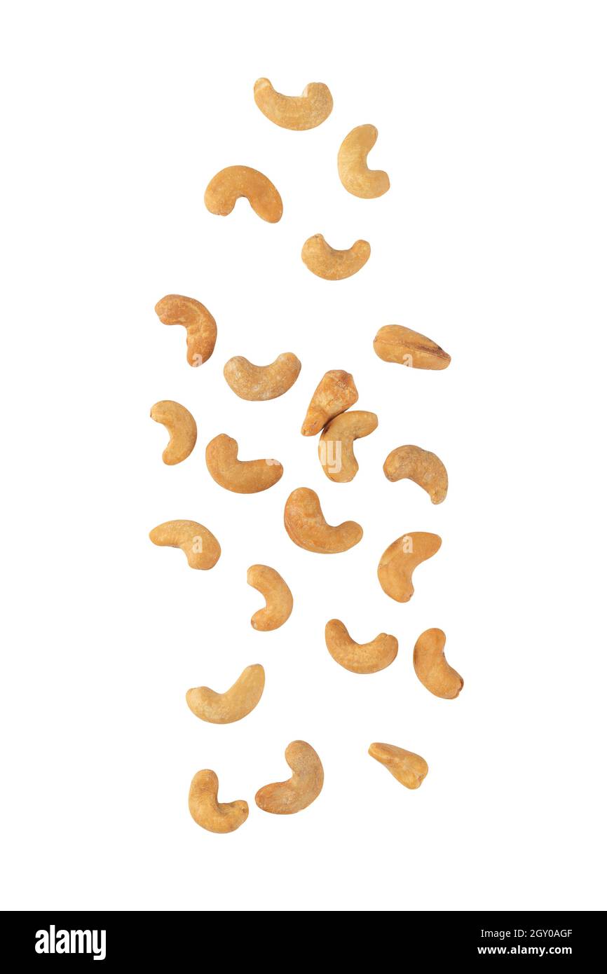 Cashew nuts falling isolated on white background with clipping path. Stock Photo