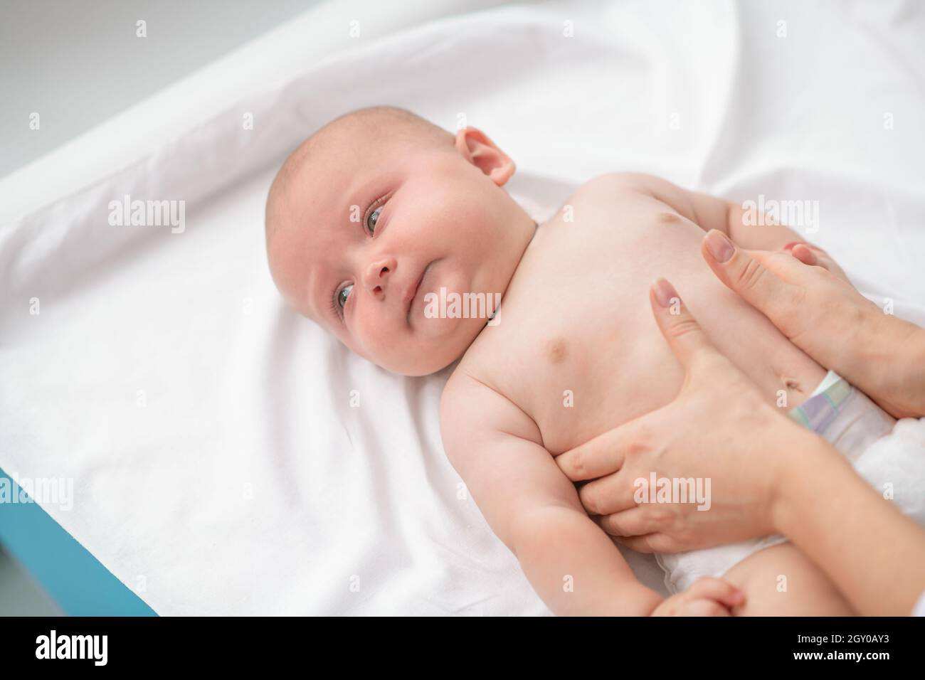 Calm baby undergoing a medical exam in hospital Stock Photo
