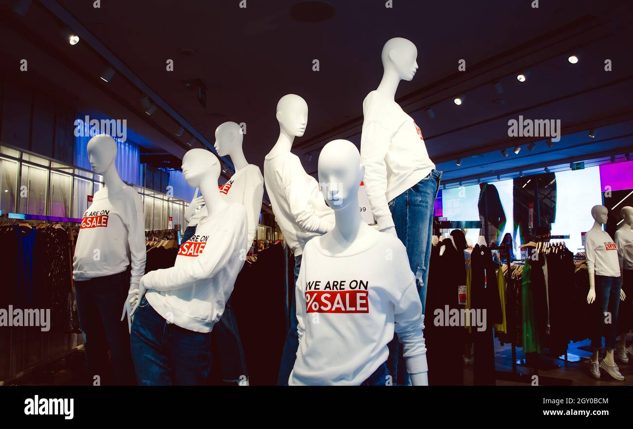 female mannequins dressed in casual clothes with sale text in the shopping department store Stock Photo