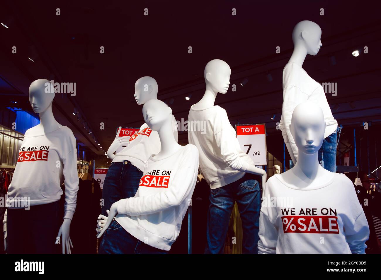 female mannequins dressed in casual clothes with sale text in the shopping department store Stock Photo