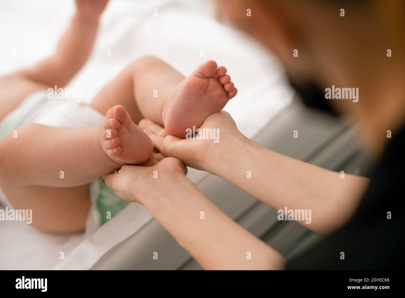 Certified physiotherapist performing a neonatal neurological assessment Stock Photo