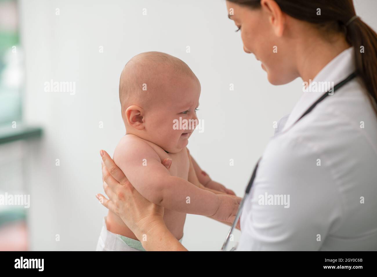 Experienced pediatrician examining a newborn baby Stock Photo