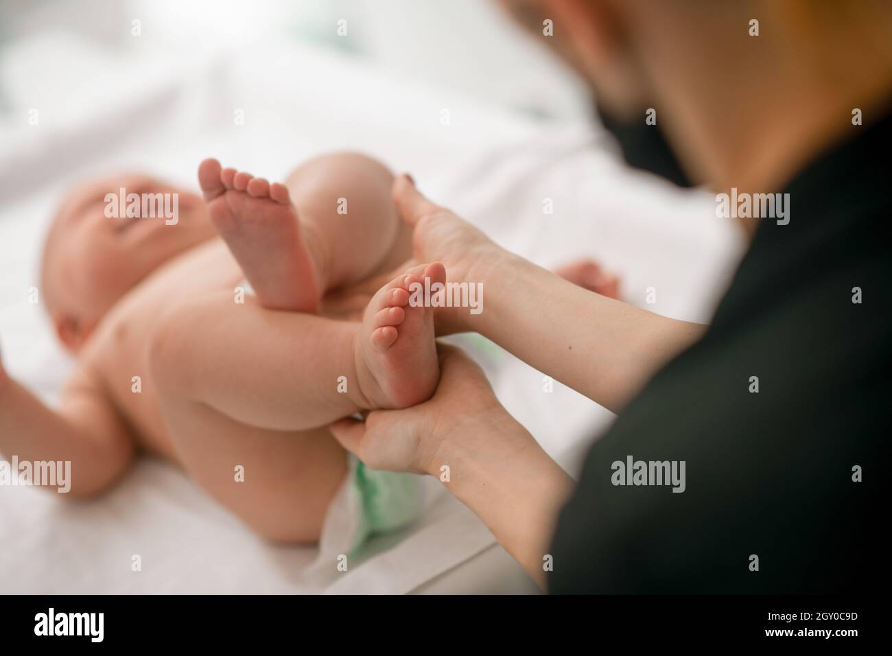 Pediatric patient being tested for neonatal reflexes Stock Photo
