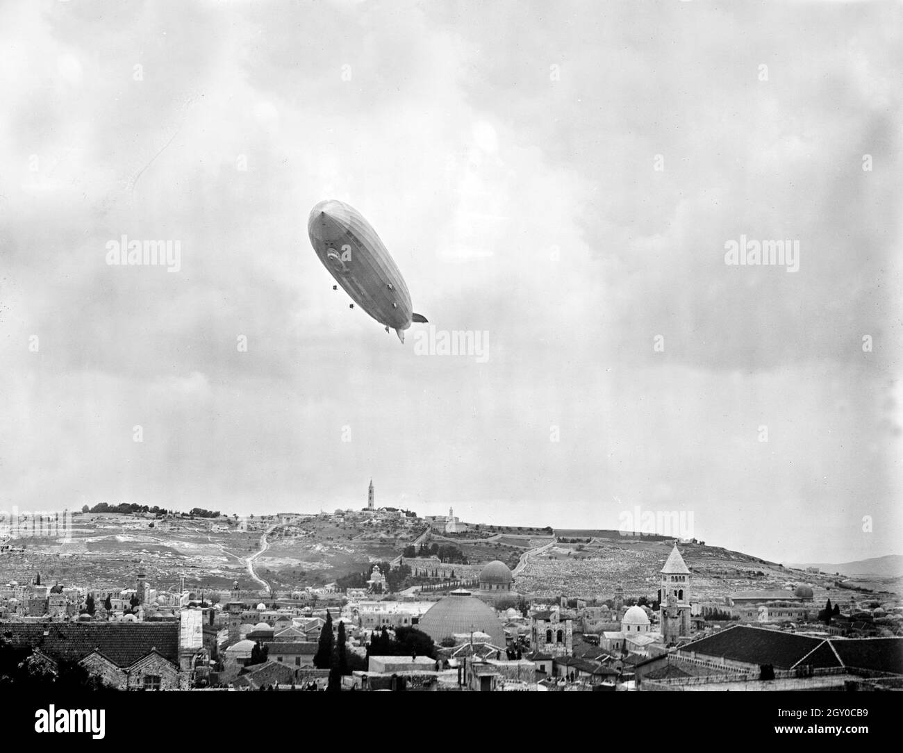 Vintage photo circa April 1931 of the German passenger carrying rigid airship Graf Zeppelin flying over Jerusalem in Israel Stock Photo