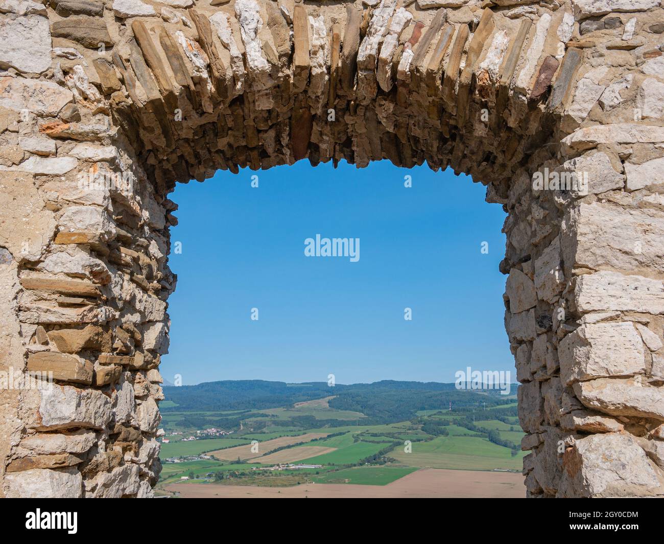 Bricked window opening from old ruin with beautiful view Stock Photo