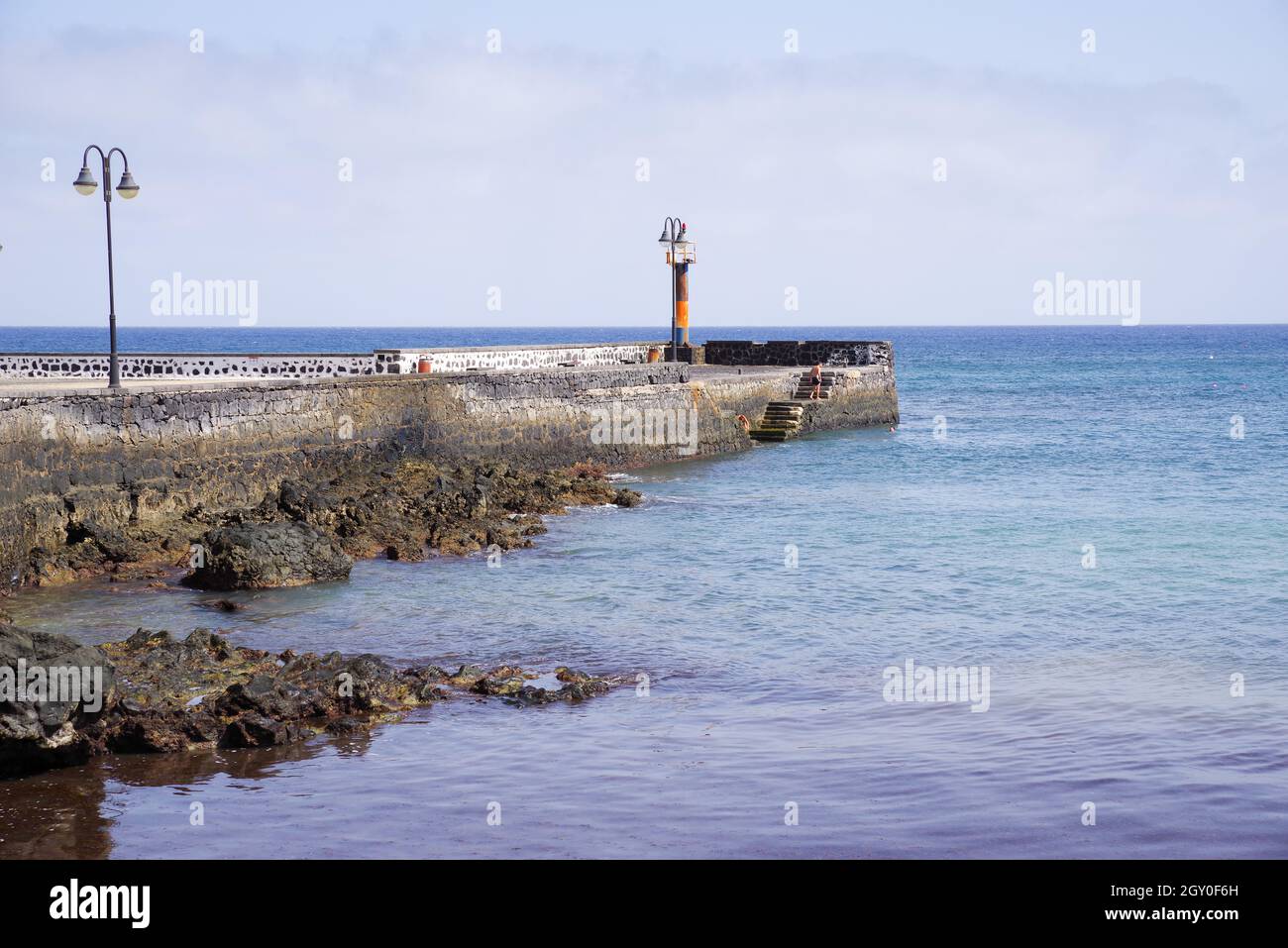 Jetty and seawall in Arrieta - northern Lanzarote, Canary Islands Stock Photo