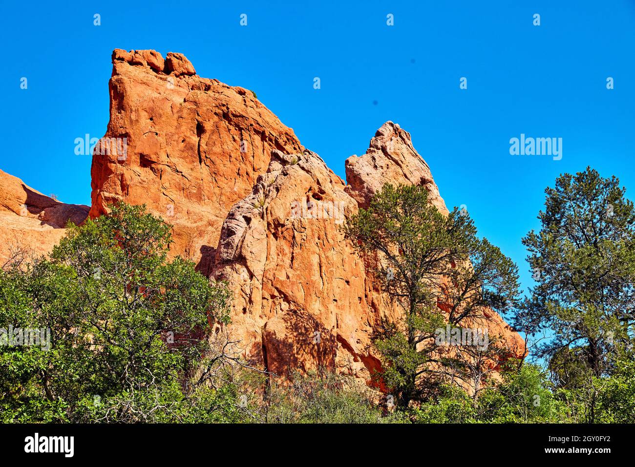 Sheet of red rock pillar mountains with green trees Stock Photo Alamy