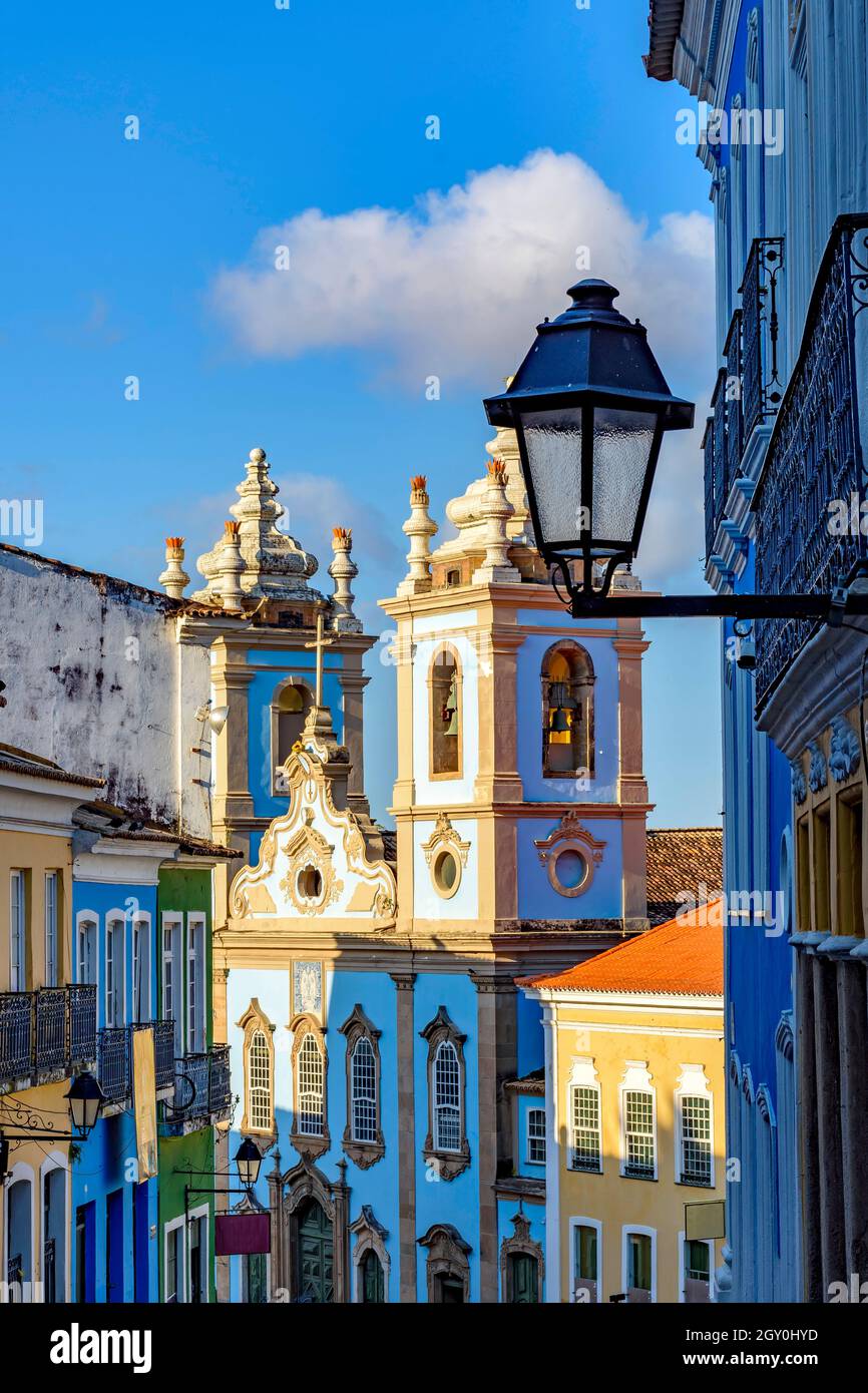 Colorful colonial houses facades and historic church towers in baroque and colonial style with blue sky in the famous Pelourinho district of Salvador, Stock Photo