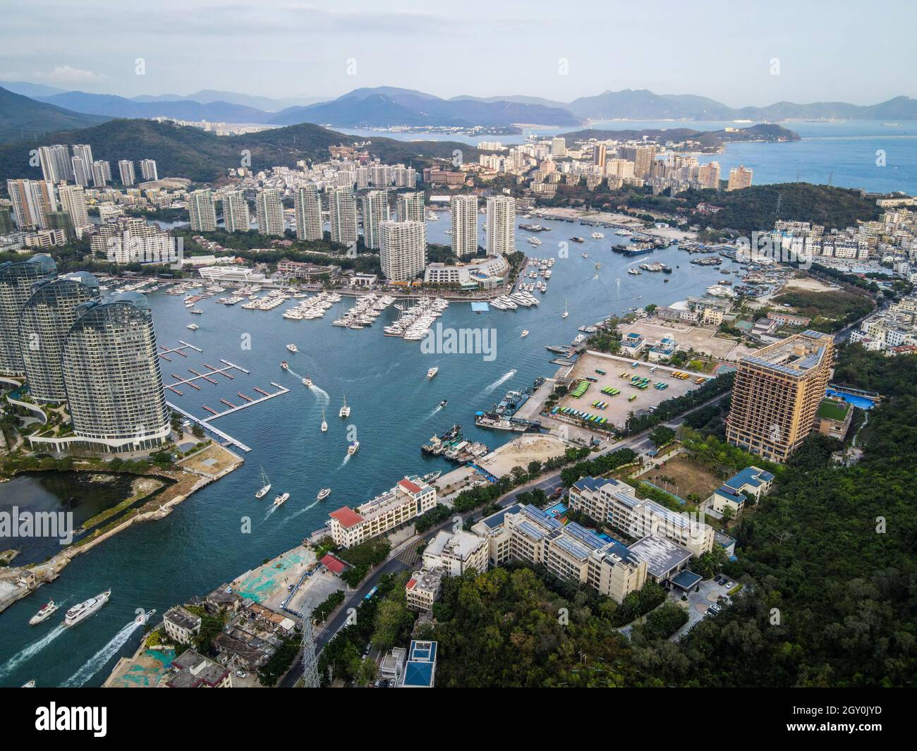 Aerial drone shot cityscape of Sanya city with marina and buildings on Hainan tropical island China Stock Photo