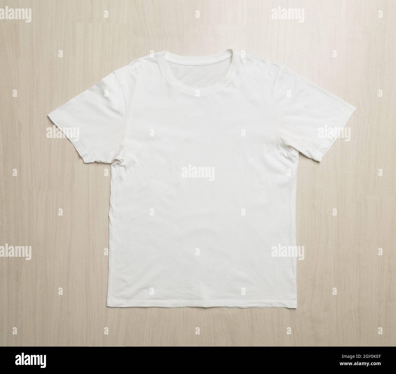 White T-shirts mockup template on wooden floor. Stock Photo